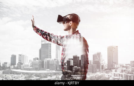 Ragazzo indossa controllato shirt e maschera virtuale di stiro a mano a Foto Stock