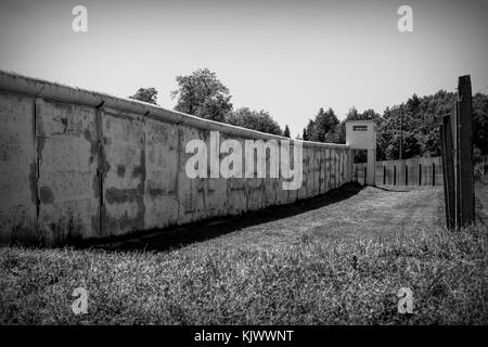 Nel 1989 la rivoluzione pacifica ha strappato il muro. Prima del 9 novembre 1989 la cortina di ferro era una zona di morte in Germania: 245 persone, che volevano fuggire dalla Germania orientale, furono uccise nel tentativo di attraversare questo confine disumano. MoedLareuth, un piccolo villaggio, è stato seperato da questo muro in una parte occidentale e orientale come a Berlino. Per questo motivo si chiamava piccola Berlino. La foto è scattata nel Museo tedesco-tedesco di MoedLareuth. Foto Stock