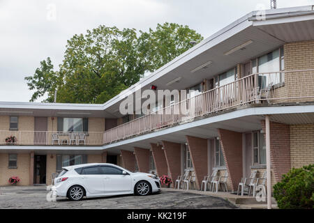 Un bianco auto presso la tipica del nord america edificio motel Foto Stock