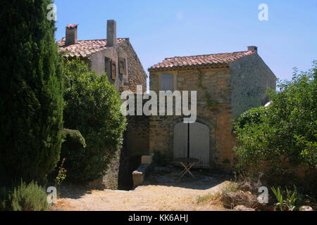 Rue des Coquillages, Vaugines, Vaucluse Francia: tetti di tegole e cipresso Foto Stock