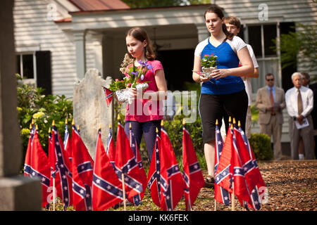 I bambini collocano fiori sulle tombe confederate del Confederate Cemetery per celebrare il Confederate Memorial Day il 10 maggio 2011 a Mount Pleasant, South Carolina. La Carolina del Sud è uno dei tre stati che segna la giornata come festa pubblica. Foto Stock