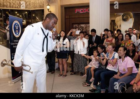 Il musicista di terza classe Michael Bookman, membro della 7th Fleet far East Edition Brass Band, canta per i cittadini thailandesi durante uno spettacolo al Terminal 21 Mall di Bangkok, Thailandia. Per gentile concessione di Mass Communication Specialist 3rd Class Colin M. Sheridan/US Navy, 2012. Foto Stock