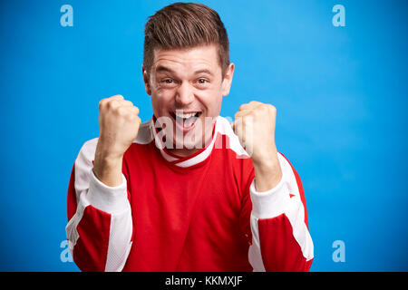 Un giovane maschio bianco Ventilatore sport tifo e celebrando Foto Stock