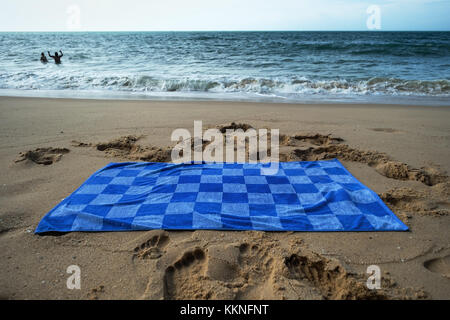 Asciugamani blu sulla spiaggia sabbiosa Foto Stock
