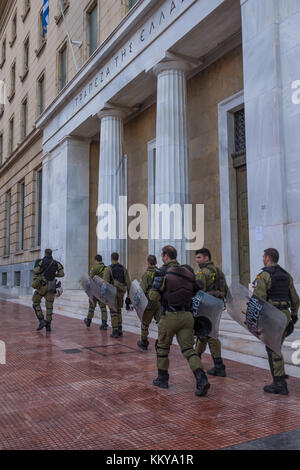 ATHENS, Grecia - 18 novembre 2017: Riot Police con il loro scudo, prendere la copertura durante il raduno di fronte all Università di Atene, che è sotto l'occupazione b Foto Stock