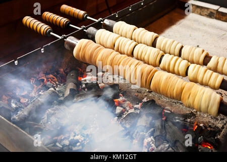 Torta di camino chiamato trdlo o trdelnik, mercatino di natale, Piazza Venceslao, Città Vecchia, Praga, repubblica Ceca - cibo di strada tradizionale Foto Stock