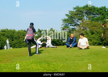 Le persone sono rilassanti sul prato della Baia di Shenzhen park. A shenzhen, Cina. Foto Stock