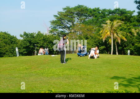 Le persone sono rilassanti sul prato della Baia di Shenzhen park. A shenzhen, Cina. Foto Stock