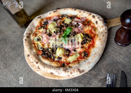 Autentica Pizza italiana sulla superficie rustico Foto Stock
