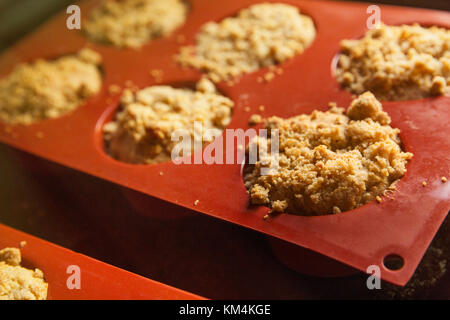 Angolo alto close up di pane appena sfornato dolci di piccole dimensioni in stampo in silicone. Foto Stock