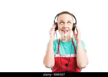 Ipermercato dipendente ascoltando musica sulle cuffie da indossare grembiule rosso isolato su sfondo bianco Foto Stock