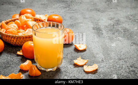Spremuta fresca di ripe tangerini. su sfondo rustico. Foto Stock