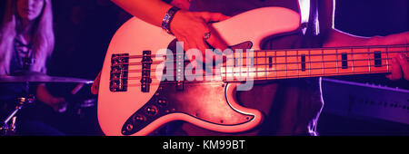 La sezione centrale del chitarrista femmina a suonare la chitarra con il batterista in discoteca Foto Stock