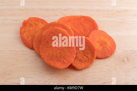 Più salati carota chip su un legno tagliere. Foto Stock