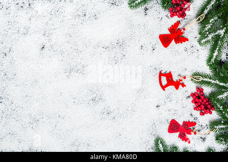 Sfondo di natale con i fiocchi di neve, il bianco della neve, giocattoli, candy, albero di natale rami e anno nuovo decor. vacanze inverno telaio Foto Stock