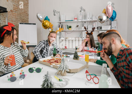Amici e colleghi di celebrare il Natale in ufficio Foto Stock