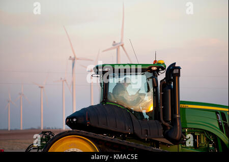 Agricoltore IN CABINA LA PREPARAZIONE DI TRATTORE JOHN DEERE Foto Stock