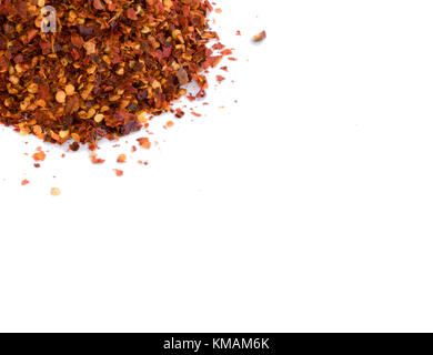 Peperoncino essiccato pezzi di peperone rosso schiaccia isolato su sfondo bianco con un sacco di spazio di copia Foto Stock