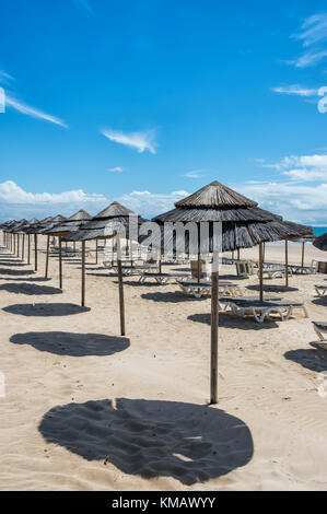 Vuoto spiaggia con lettini per prendere il sole e parosols Foto Stock