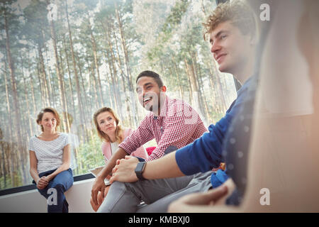 Sorridente gente che ascolta nella sessione di terapia di gruppo Foto Stock