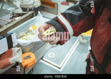 La sezione centrale del pescatore numero dell'azienda tag Foto Stock