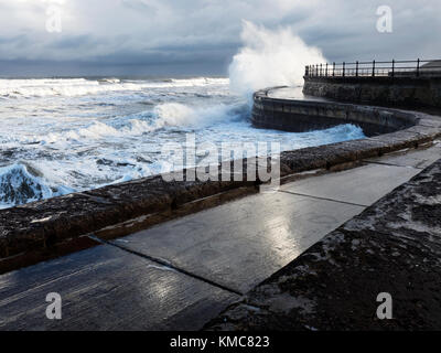 Onde che si infrangono sulle mura sul mare ad alta marea in South Bay a Scarborough North Yorkshire, Inghilterra Foto Stock