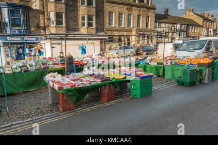 Un cliente effettua un acquisto presso un frutta e verdura, stallo Barnard Castle Mercato, Teesdale, a nord-est dell' Inghilterra, Regno Unito. Dicembre 2017 Foto Stock