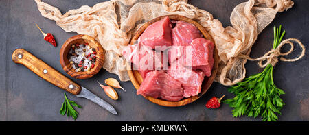 Materie carne tritata con spezie su sfondo arrugginito Foto Stock