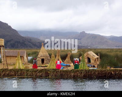 Puno, Perù - Gennaio 1, 2007: villaggio galleggiante del popolo Uros sul lago Titicaca. uomini e donne nel tipico abito. Foto Stock