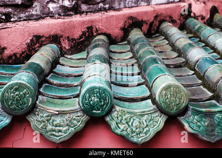 Impressione con decorazione brillante sul tetto del tempio in stile cinese, yin e yang piastrella, antica consistenza e roof top in rosso, ciano di Ho Chi Minh Foto Stock