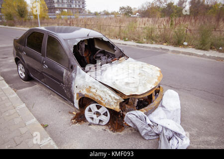 Auto bruciata dal lato della strada Foto Stock