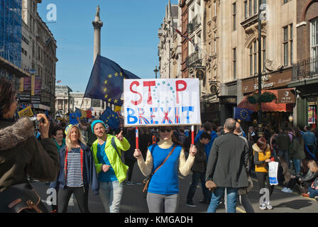 Anti Brexit dimostrazione. Giovane donna nel mezzo di demo azienda banner 'Stop Brexit' , bandiera UE dietro. Colouful Foto Stock