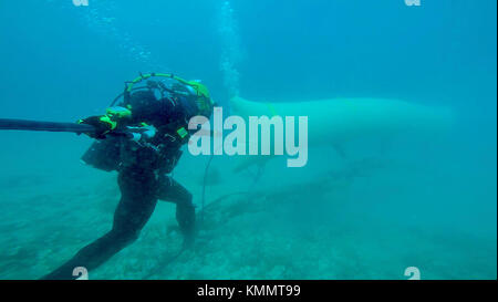 Stati Uniti Costruzione navale meccanico 2a classe Robert Norton, Seabee assegnato alla costruzione subacquea Team 2 Costruzione Diving distacco ALFA (CDDA), si stacca il flessibile aria dopo il gonfiaggio 3.000 lb sacchi di sollevamento collegati a catene di ormeggio in Apra Harbor, Guam il 25 novembre 2017. CDDA sta conducendo la sistematica rimozione di 10.000 piedi di catena di ormeggio lasciato dalla ex bacino di carenaggio Ex-Machinist, conosciuto localmente come "Big Blue", utilizzando varie subacquea tecniche di costruzione. CDDA è sulla quarta fermata dei loro sei mesi di distribuzione, dove stanno conducendo ispezione, manutenzione, e re Foto Stock