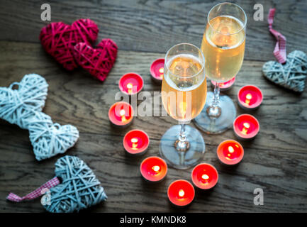 Due bicchieri di champagne all'interno di candele accese Foto Stock