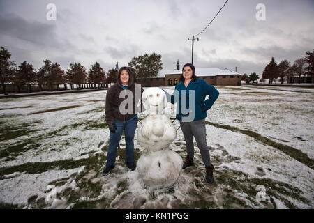 Mandeville, Louisiana, Stati Uniti. 8 dicembre 2017. Molly Ganger e Rose Highnote posano con un pupazzo di neve che hanno costruito nel tardo pomeriggio sulla riva del lago Pontchartrain nel Fontainebleau State Park. Un mix invernale di precipitazioni è caduto in diversi stati del profondo Sud causando la chiusura di molte aziende e scuole. Crediti: Julie Dermansky/ZUMA Wire/Alamy Live News Foto Stock