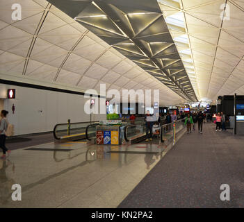 Persone che viaggiano attraverso l'aeroporto di Hong Kong Foto Stock