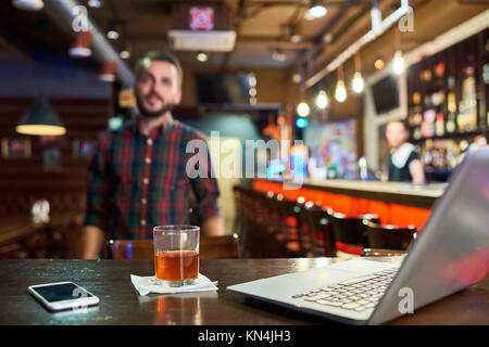 Giovane uomo che lavora in bar Foto Stock