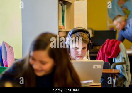 Ragazzo adolescente e una ragazza facendo lavori scolastici a banchi Foto Stock