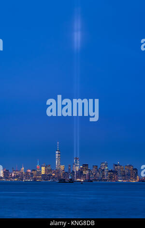 New York skyline della città con i grattacieli e i due fasci del tributo in luce. La parte inferiore di Manhattan, il Quartiere Finanziario, il porto di New York