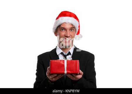 Foto di felice ragazzo nel business suit, cap di Santa con doni nella casella Foto Stock