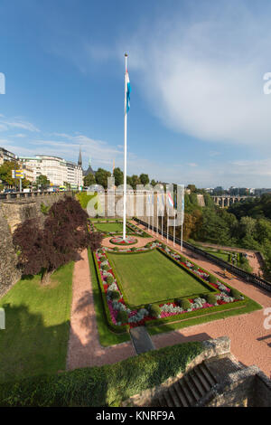 Città Luxemburg, Lussemburgo. Vista pittoresca dei giardini di Piazza della Costituzione, con il monumento du souvenir in background. Foto Stock