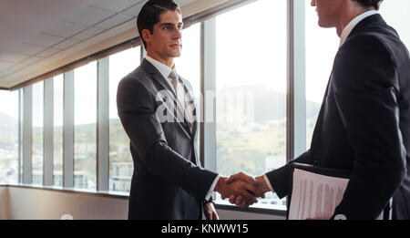 uomini d'affari stringono la mano dopo un accordo in ufficio. Concetto di saluto, trattativa, fusione e acquisizione. Foto Stock