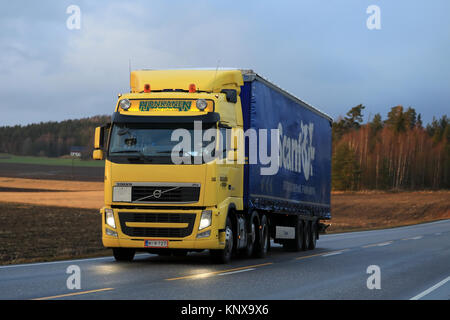 SALO, Finlandia - 8 dicembre 2017: Giallo Volvo FH di Kuljetusliike Honkanen semi rimorchio trasporta merci lungo l autostrada in un pomeriggio invernale in Sud Foto Stock