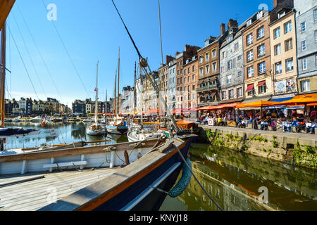 Una fila di ristoranti e caffetterie alla pittoresca cittadina di pescatori e molo vecchio sulla costa della Normandia a Honfleur Francia Foto Stock