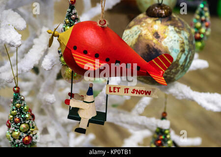 Natale robot a cavallo rosso blimp con Let it Snow segno su soffici albero di Natale con altri ornamenti Foto Stock