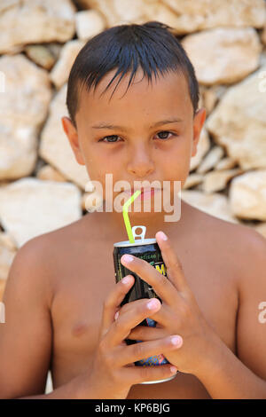 9-anno-vecchio ragazzo di bere. Foto Stock