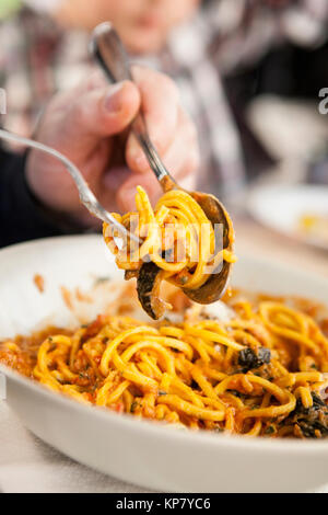 La cena per gli ospiti fino a rotolamento spaghetti su una forcella Foto Stock