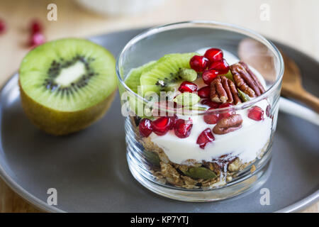 Muesli con yogurt greco ,Kiwi e melograno Foto Stock