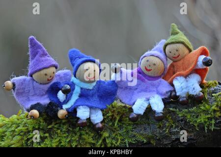 Quattro gnomi piccoli si siedono nel muschio Foto Stock