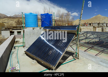 Calorifero di acqua solare collettore e i serbatoi sul tetto di una guesthouse in Lo Mantang, Mustang Superiore regione, Nepal. Foto Stock